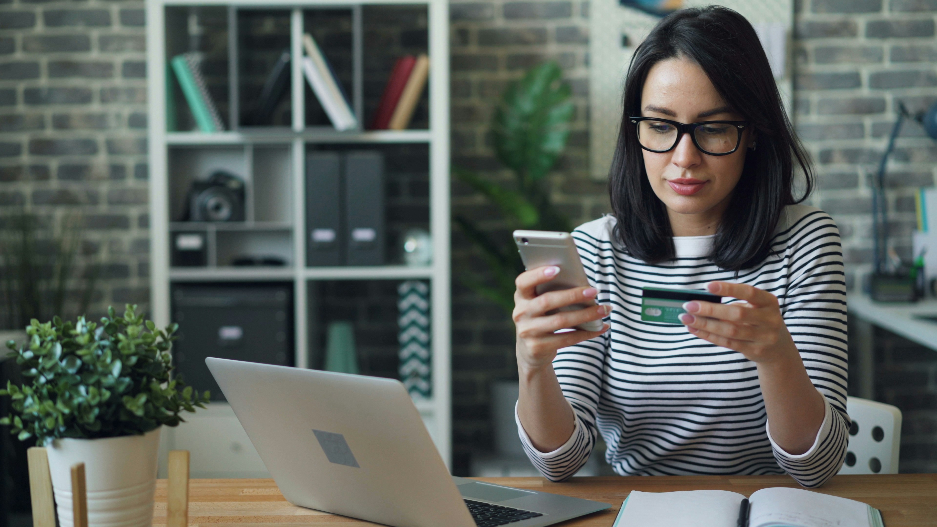 Woman Holding Credit Card and Phone